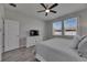 Bedroom featuring wood-look floors, natural light, a ceiling fan, and a dresser with a TV at 12123 Ledbury Commons Dr, Gibsonton, FL 33534