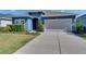 Charming single-story home featuring a well-manicured lawn and a two-car garage at 12123 Ledbury Commons Dr, Gibsonton, FL 33534