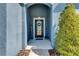 Inviting front porch with a decorative wreath on the front door and manicured landscaping at 12123 Ledbury Commons Dr, Gibsonton, FL 33534