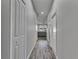 Bright hallway featuring wood-look tile and leads to the living area, creating an inviting flow at 12123 Ledbury Commons Dr, Gibsonton, FL 33534