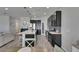 Open concept kitchen with stainless steel appliances, large island, and dark cabinetry at 12123 Ledbury Commons Dr, Gibsonton, FL 33534