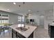 Stylish kitchen island with pendant lighting, stainless steel sink, and view of the living area for seamless entertaining at 12123 Ledbury Commons Dr, Gibsonton, FL 33534