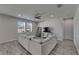 Bright living room features a comfortable gray sectional sofa, modern decor, and plenty of natural light at 12123 Ledbury Commons Dr, Gibsonton, FL 33534