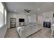Open living space featuring a gray sectional sofa, media console, and seamless flow to the kitchen and dining areas at 12123 Ledbury Commons Dr, Gibsonton, FL 33534