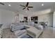 Bright open-concept living room with tile floors, inviting gray sectional sofa, and stylish decor at 12123 Ledbury Commons Dr, Gibsonton, FL 33534