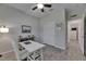 Office space featuring wood-look floors, a modern desk setup, and ample natural light from windows at 12123 Ledbury Commons Dr, Gibsonton, FL 33534