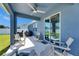 Relaxing covered patio with ceiling fan, comfortable seating, and view of fenced yard at 12123 Ledbury Commons Dr, Gibsonton, FL 33534