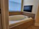 This bathroom features a soaking tub with tile surround and a window at 13400 Old Florida Cir, Hudson, FL 34669