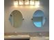 This bathroom features a dual sink vanity with oval mirrors and lighting at 13400 Old Florida Cir, Hudson, FL 34669