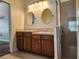 This bathroom features a dual sink vanity, and glass-enclosed shower at 13400 Old Florida Cir, Hudson, FL 34669