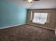 This carpeted bedroom features a sunny window nook with comfortable pillows at 13400 Old Florida Cir, Hudson, FL 34669