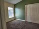 Comfortable bedroom with natural light, green accent wall, closet space, creating a perfect space to relax and unwind at 13400 Old Florida Cir, Hudson, FL 34669