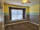Inviting bedroom featuring stylish color-block walls, window, and plush carpeting for a warm and cozy ambiance at 13400 Old Florida Cir, Hudson, FL 34669
