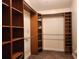 This walk-in closet features built-in wooden shelving and clothing racks at 13400 Old Florida Cir, Hudson, FL 34669