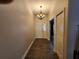 Inviting entryway with wood-look floors, a classic chandelier, and a clear view to the front door at 13400 Old Florida Cir, Hudson, FL 34669
