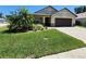 Charming single-story home with manicured lawn and attached two-car garage at 13400 Old Florida Cir, Hudson, FL 34669