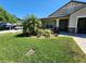 Charming single-Gathering home with well-manicured lawn, palm trees, and a brick-paved driveway at 13400 Old Florida Cir, Hudson, FL 34669