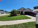 Charming single-Gathering home with well-manicured lawn, palm trees, and a red truck parked in the driveway at 13400 Old Florida Cir, Hudson, FL 34669