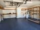 Spacious garage with a painted floor, shelving, a sink, and an electric garage door opener at 13400 Old Florida Cir, Hudson, FL 34669
