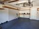 Spacious garage with a painted floor, shelving, and an electric garage door opener at 13400 Old Florida Cir, Hudson, FL 34669