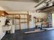Spacious garage with a painted floor, shelving, a sink, a water heater, and an electric garage door opener at 13400 Old Florida Cir, Hudson, FL 34669