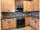 The kitchen features granite countertops, custom backsplash and stainless steel appliances at 13400 Old Florida Cir, Hudson, FL 34669