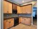 The kitchen includes stainless steel appliances, granite countertops and tile floors at 13400 Old Florida Cir, Hudson, FL 34669