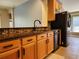 Kitchen featuring a stainless steel dishwasher and refrigerator plus granite countertops at 13400 Old Florida Cir, Hudson, FL 34669