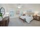 Bright bedroom featuring a plush carpet, modern decor, and ample natural light at 14936 Salamander Pl, Tampa, FL 33625