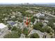 A quaint home situated in a vibrant neighborhood with mature trees and city views in the background at 1603 S Arrawana Ave, Tampa, FL 33629