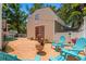 Relaxing backyard patio with comfortable seating, a fire pit, and lush landscaping at 1603 S Arrawana Ave, Tampa, FL 33629