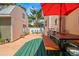 Charming backyard boasting an outdoor dining set, patio space, and lush tropical landscaping at 1603 S Arrawana Ave, Tampa, FL 33629