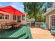 Inviting backyard features an outdoor dining area, screened porch, and lounging space with a hot tub at 1603 S Arrawana Ave, Tampa, FL 33629