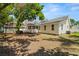 Large backyard with mature trees, a hot tub and a screened porch at 1603 S Arrawana Ave, Tampa, FL 33629