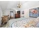 Bedroom featuring vaulted ceilings, a bed, nightstand, dresser, sitting area and an art piece at 1603 S Arrawana Ave, Tampa, FL 33629