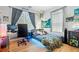 Modern bedroom featuring stylish decor, a comfortable bed, and a gaming setup at 1603 S Arrawana Ave, Tampa, FL 33629