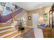 Inviting foyer with hardwood floors, staircase, and decorative accents at 1603 S Arrawana Ave, Tampa, FL 33629