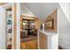 Hallway featuring hardwood floors, built-in shelving, and an open area with cozy seating at 1603 S Arrawana Ave, Tampa, FL 33629