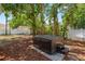 Backyard with a relaxing hot tub on a mulch bed with mature trees at 1603 S Arrawana Ave, Tampa, FL 33629