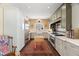 Well-equipped kitchen showcasing stainless steel appliances, custom cabinets, a farmhouse sink, and hardwood flooring at 1603 S Arrawana Ave, Tampa, FL 33629