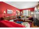 Inviting living room features red walls, classic furnishings, and ample natural light, creating a warm and cozy atmosphere at 1603 S Arrawana Ave, Tampa, FL 33629