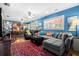Spacious living room with blue walls, lots of natural light, and a variety of decorations at 1603 S Arrawana Ave, Tampa, FL 33629