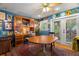 Comfortable office with built-in wooden desk, hutch, and glass doors to the backyard area at 1603 S Arrawana Ave, Tampa, FL 33629