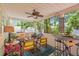 Enclosed porch featuring wooden floors, seating options, and a ceiling fan with a view of the backyard at 1603 S Arrawana Ave, Tampa, FL 33629