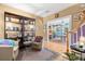 Sitting room with built-in shelving and hardwood floors, leading to an open office space at 1603 S Arrawana Ave, Tampa, FL 33629
