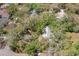 Overhead shot of property nestled among trees; pool on property is also visible in shot at 187 Sage Cir, Crystal Beach, FL 34681