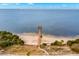 Breathtaking aerial view of a pier stretching into the serene bay waters at 187 Sage Cir, Crystal Beach, FL 34681