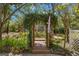 Lush backyard with garden and wooded walkway at 187 Sage Cir, Crystal Beach, FL 34681