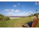 Relaxing beach view featuring a bench, pier, and clear blue skies over the water at 187 Sage Cir, Crystal Beach, FL 34681
