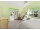 Bright bedroom with light green walls and double doors to outdoor patio at 187 Sage Cir, Crystal Beach, FL 34681